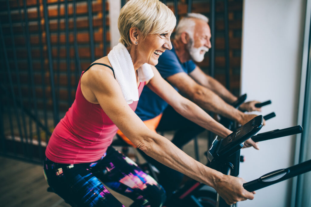 A man and woman riding stationary bikes