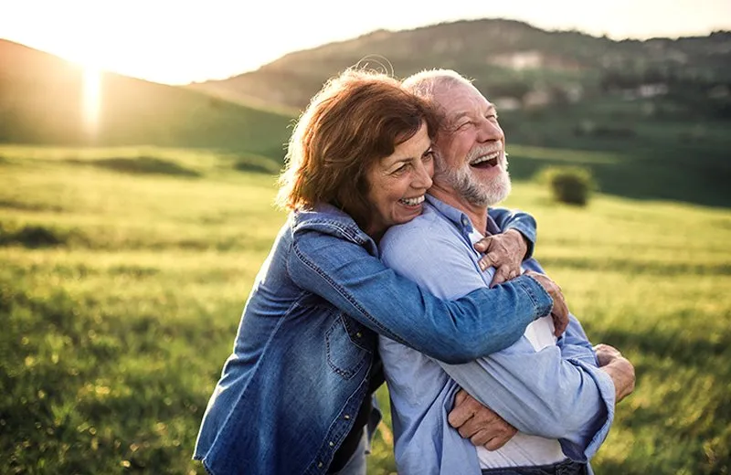 A man and woman Standing outdoors and smiling A man and woman Standing outdoors and smiling